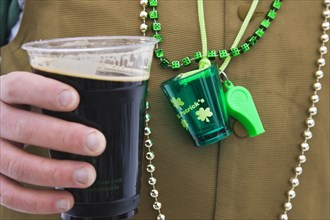 20091056 Detail man wearing various green items whilst drinking pint stout beer. Model Released American Male Men Guy North America One individual Solo Lone Solitary United States America  Dominant Gr...