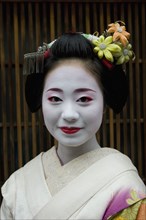 JAPAN, Honshu, Kyoto, "Gion District.  Head and shoulders portrait of smiling apprentice Geisha or