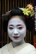JAPAN, Honshu, Kyoto, "Gion District.  Head and shoulders portrait of smiling Maiko or apprentice