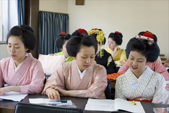JAPAN, Honshu, Kyoto, Gion District.  Geisha and Maiko apprentice Geisha attending a class at Mia