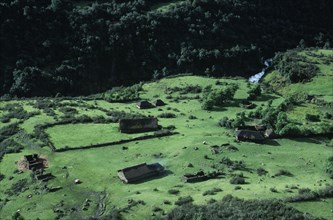 PERU, Ayacucho Province, Lijiana, Aerial view over settlement amongst green agricultural landscape