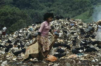 ECUADOR, Guayas Province, Guayaquil , The city rubbish tip with a girl searching for items to