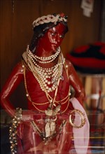 BRAZIL, Salvador da Bahia, Red statue of Jesus Christ used in Umbanda ceremonies adorned with pearl