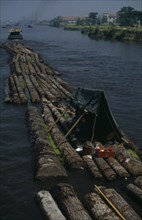 CHINA, Jiangsu Province, Transport, Log rafts on the Grand Canal between Suzhou and Wuxi. Men
