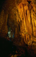 CHINA, Guangxi, Guilin, Reed Flute Caves. Rock formations in golden light