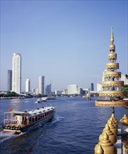 THAILAND, Bangkok, "View across Chao Phraya River from Wat Ratchasungkhon decorated with gold
