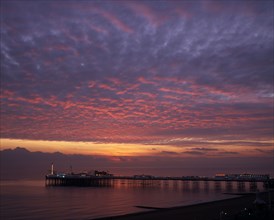 ENGLAND, East Sussex, Brighton, Early Autumn sunset from Marine Parade with Brighton Pier and