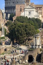ITALY, Lazio, Rome, View of The Forum with the Colosseum rising behind the bell tower of the church