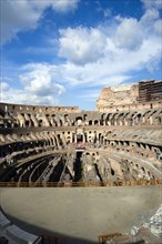 ITALY, Lazio, Rome, The Colosseum amphitheatre interior with tourists built by Emperor Vespasian in