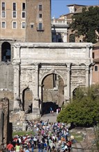 ITALY, Lazio, Rome, Tourists walking towards the triumphal Arch of Septimius Severus in the Forum