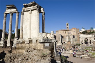 ITALY, Lazio, Rome, The Forum with tourists. The Temple of The Vestals on the left and the Arch of