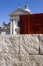 ITALY, Lazio, Rome, Neo Classical Church of San Rocco and red perspex cube behind a stone wall at