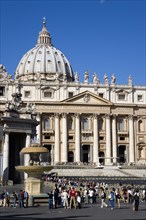 ITALY, Lazio, Rome, Vatican City The Basilica of St Peter with tourists at the entrance and in the