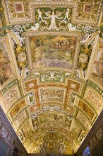 ITALY, Lazio, Rome, Vatican City Museums The highly decorated illuminated ceiling of the Gallery of
