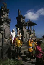 INDONESIA, Bali, Besakih Temple, Procession of mourners leaving cremation ceremony in temple