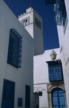 TUNISIA, Sidi Bou Said, "Part view of white painted mosque with decorative, blue painted balconies,