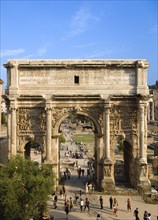 ITALY, Lazio, Rome, Tourists walking around the triumphal Arch of Septimus Severus in the Forum
