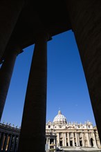 ITALY, Lazio, Rome, Vatican City The Basilica of St Peter seen through the pillars of the