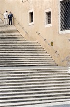 ITALY, Lazio, Rome, Two men talking in conversation on steps beside the Palazzo dei Conservatori on