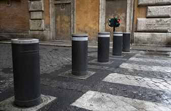ITALY, Lazio, Rome, Automatic rising bollards and a pedestrian crossing in a side street with red