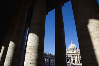 ITALY, Lazio, Rome, Vatican City The facade of the Basilica of St Peter seen through the colonnade