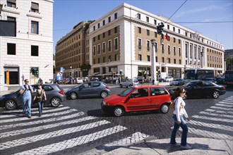 ITALY, Lazio, Rome, Pedestrian crossing with people and traffic on the Via della Conciliazione