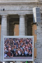 ITALY, Lazio, Rome, Vatican City Pilgrims seen on a large video TV monitor display in St Peter's