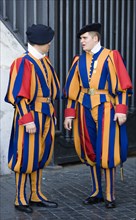 ITALY, Lazio, Rome, Vatican City Two Swiss Guards in full ceremonial uniform dress in conversation
