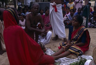SRI LANKA, Religion, Hinduism, Punnaccolai Festival. Hindu Tamil Priest wearing a red robe
