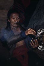LAOS, Tribal People, Meo Tribe, Meo man smoking Opium
