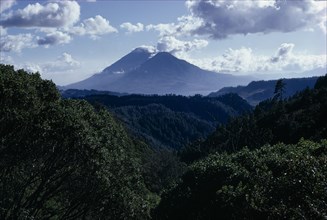 GUATEMALA, Lake Atitlan, View across dense green rainforest towards Lake Atitlan and volcanic