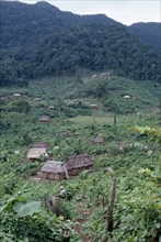 GUATEMALA, Alta Verapaz, Semuy, "Q’eqchi Indian refugee village. Thatched roof homes set amongst