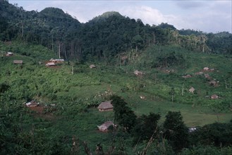 GUATEMALA, Alta Verapaz, Semuy, Q’eqchi Indian refugee village. Thatched roof homes set amongst