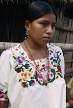 GUATEMALA, Alta Verapaz, Semuy, Portrait of a Q’eqchi Indian girl wearing a hand embroidered blouse