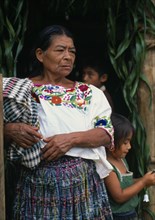 GUATEMALA, Alta Verapaz, Sacaak , Q’eqchi Indian grandmother wearing a traditional embroidered