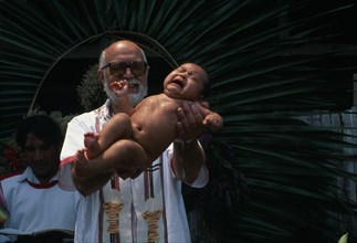 GUATEMALA, Alta Verapaz, Religion, Padre Tiziano an Italian Roman Catholic missionary baptising a