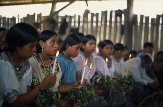GUATEMALA, Alta Verapaz, Religion, Q’eqchi Indian girls holding candles at Roman Catholic Mass