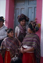 GUATEMALA, El Quiche, Nebaj, Ixil Indian women and girls gathered together at doorway in