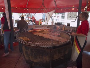 IRELAND, North, Belfast, German sausage vendor at international food festival outside the City Hall