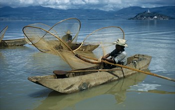 MEXICO, Michoacan, Patzcuaro, Fishermen butterfly net fishing from canoes on Lake Patzcuaro