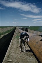 CANADA, Saskatchewan , Prairies, Constructing Trans Canada gas pipeline over Saskatchewan Prairies.