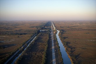 USA, Florida, Everglades, Aerial view over drainage canal and highway