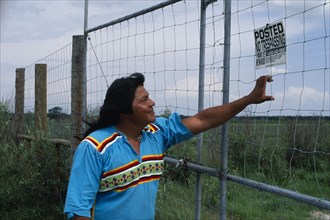 USA, Florida, Everglades, Independent Seminole Native American leader reading a No Trespassing