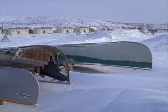 CANADA, Quebec, Hudson Bay, The Great Whale River Estuary in February with upturned canoes in deep