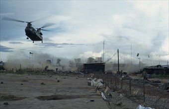 VIETNAM, Central Highlands, Kontum, "Helicopter takes off at dusk from Kontum, under siege by the