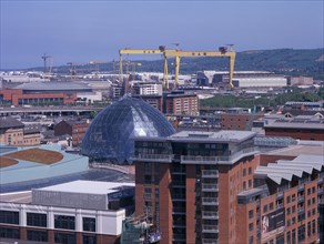 IRELAND, North, Belfast, Cityscape with Victoria Square shopping centre dome and cranes seen from