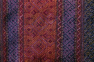 BANGLADESH, Crafts, Textiles, Detail of red and purple woven murang pinon or loin cloth.