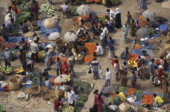 BANGLADESH, Dhaka, Elevated view over customers and vendors at fruit and vegetable street market in