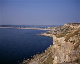 ENGLAND, Dorset, Portland, Chesil Beach viewed from quarried cliffs on north west of Isle of