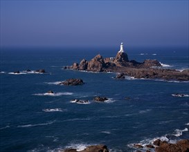 UNITED KINGDOM, Channel Islands, Jersey, St Brelade. Corbiere Lighthouse and rocky foreshore